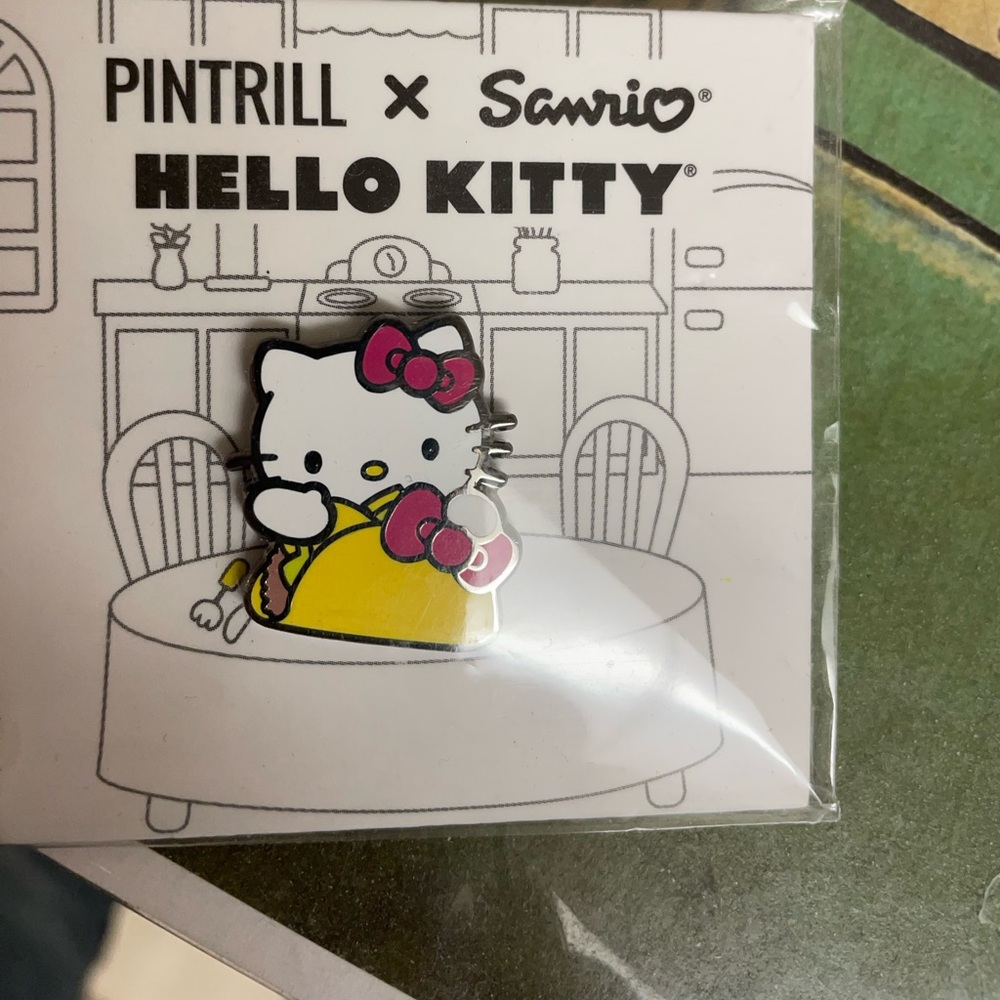 Hello kitty pin holding taco